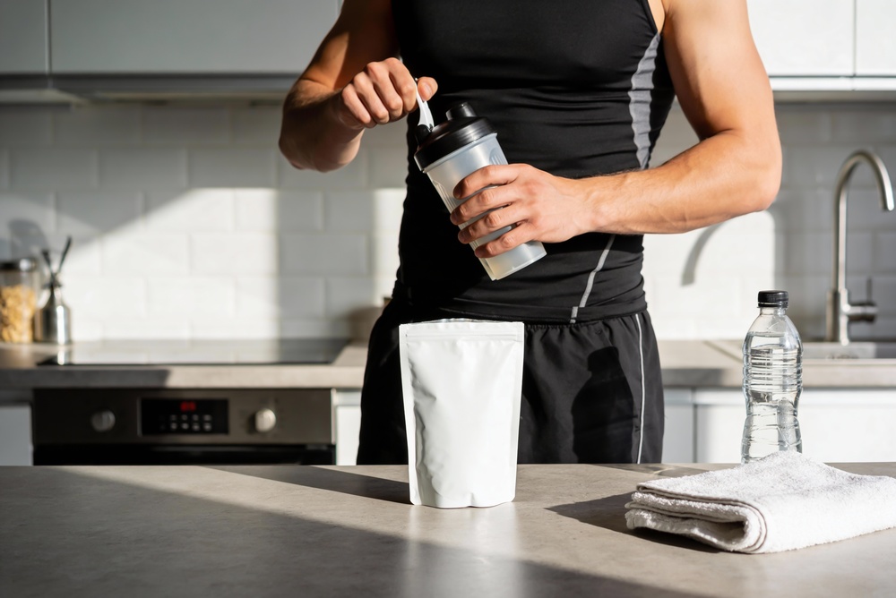 Man preparing powdered drink using clean label supplements
